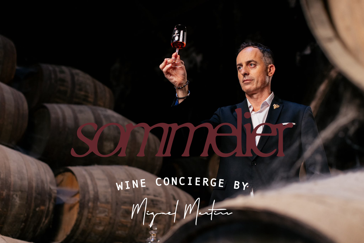 Miguel Martins, sommelier, tasting wine in a cellar, with the Sommelier Wine Concierge logo